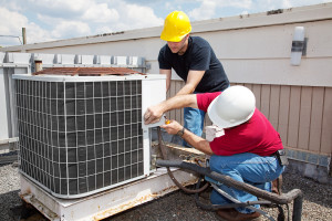 two men working to repair the ac system