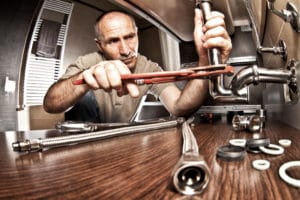 plumber at work on plumbing problems 