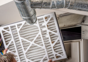 A dirty filter being changed during a typical furnace repair. 