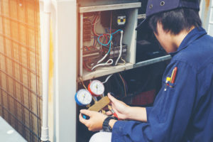 a technician conducting air conditioning repair