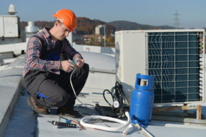 technician working on a refrigerated air unit